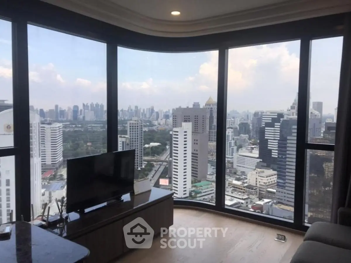 Stunning cityscape view from modern high-rise apartment with floor-to-ceiling windows.