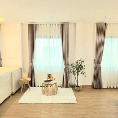 Bright and airy living room with stylish decor and large windows.