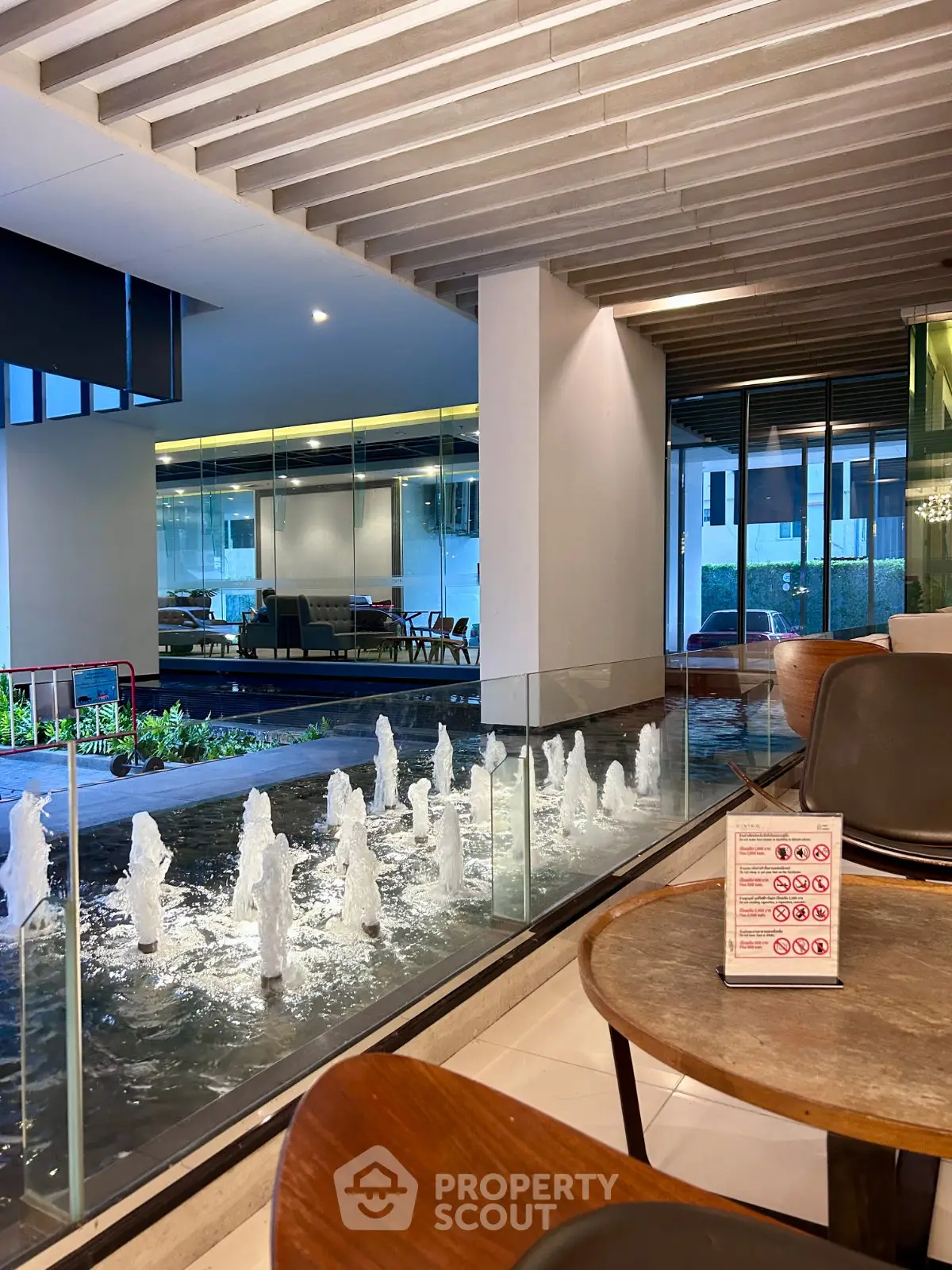 Luxurious modern lobby with elegant water feature and stylish seating area.