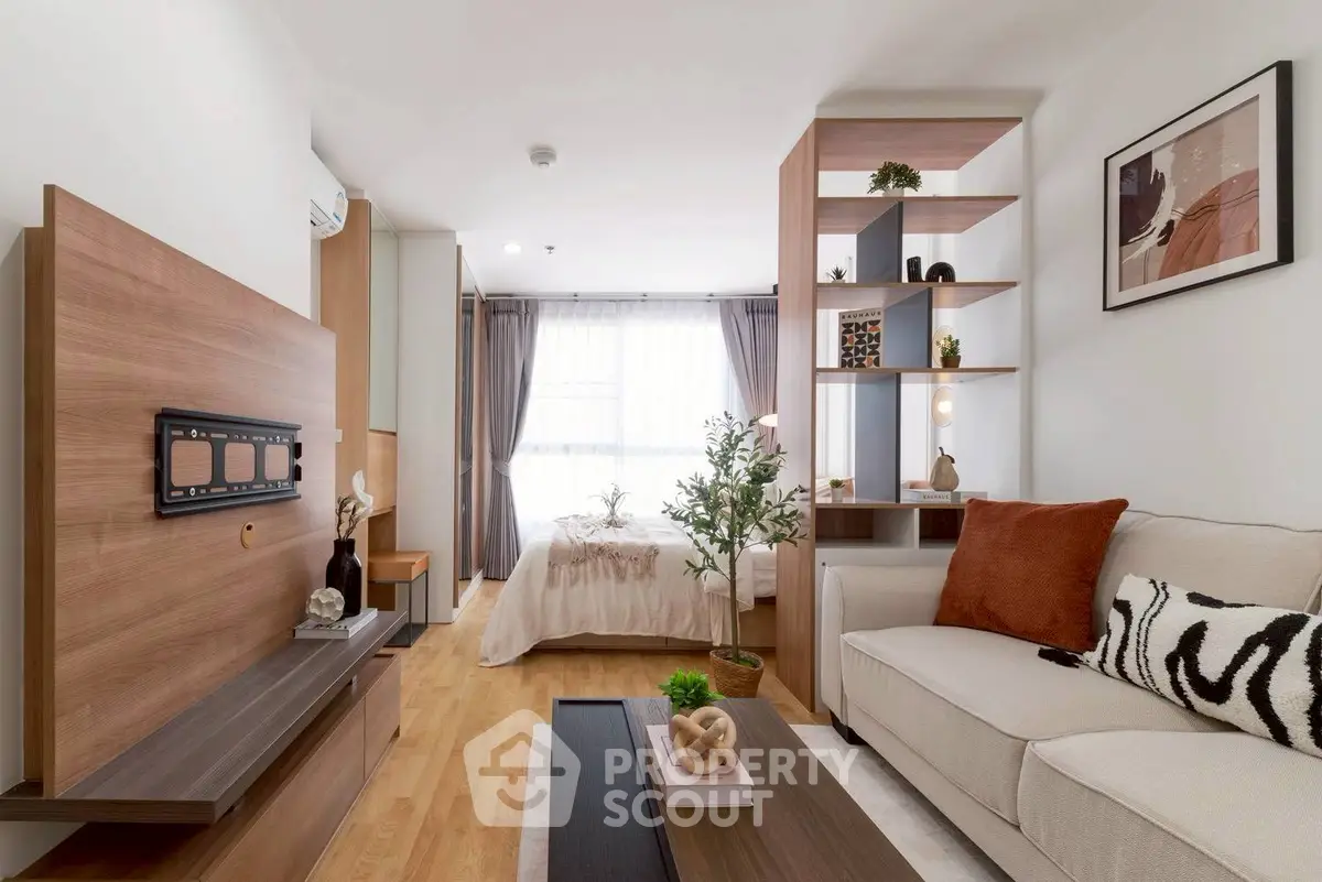 Modern studio apartment with stylish decor and open layout, featuring cozy living area and bedroom.