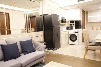 Modern open-layout kitchen with appliances and cozy living area