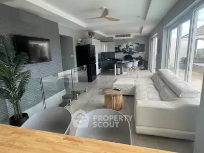 Modern open-plan living room with sleek kitchen and stylish decor