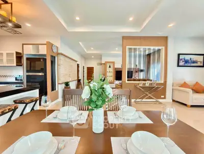 Luxurious open-plan living and dining area with modern decor and elegant furnishings.