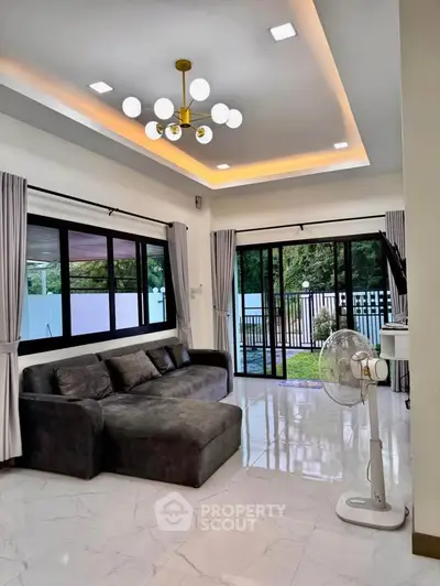 Spacious modern living room with large windows and stylish lighting