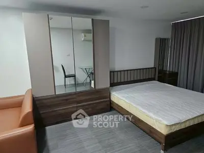 Modern bedroom with sleek furniture and minimalist design, featuring a comfortable bed and stylish wardrobe.
