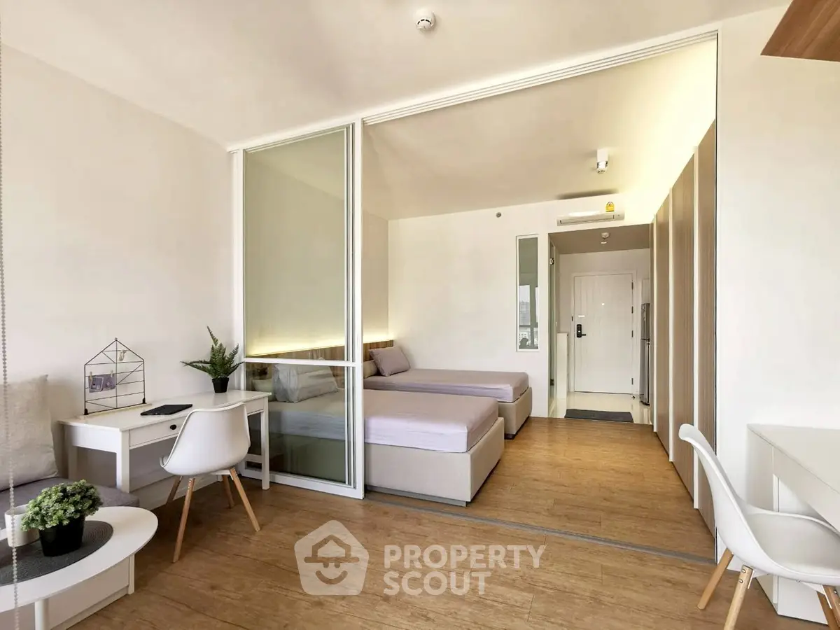 Modern studio apartment with wooden flooring and stylish furniture