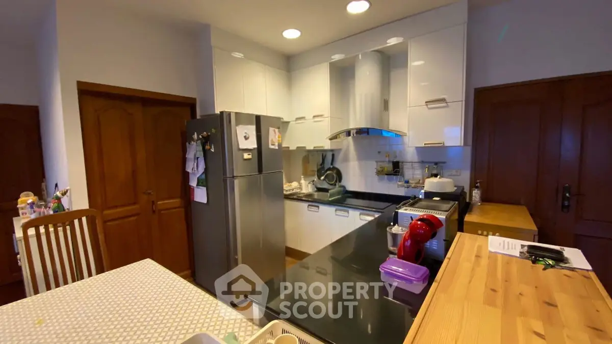 Modern kitchen with sleek appliances and stylish cabinetry, perfect for culinary enthusiasts.