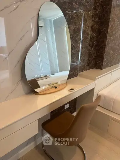 Stylish bedroom with modern vanity and unique mirror design