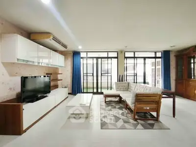 Spacious living room with modern furniture and large windows for natural light.