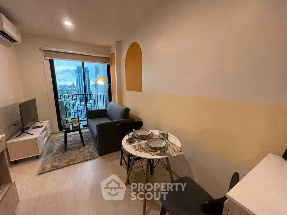 Modern living room with city view, cozy seating, and dining area in a stylish apartment.