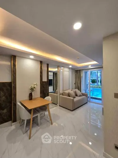 Luxurious modern living room with pool view, elegant decor, and stylish furniture.