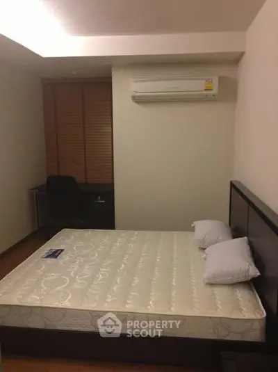 Cozy bedroom with air conditioning and modern furnishings, perfect for comfortable living.