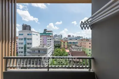Urban balcony view with cityscape and clear blue sky