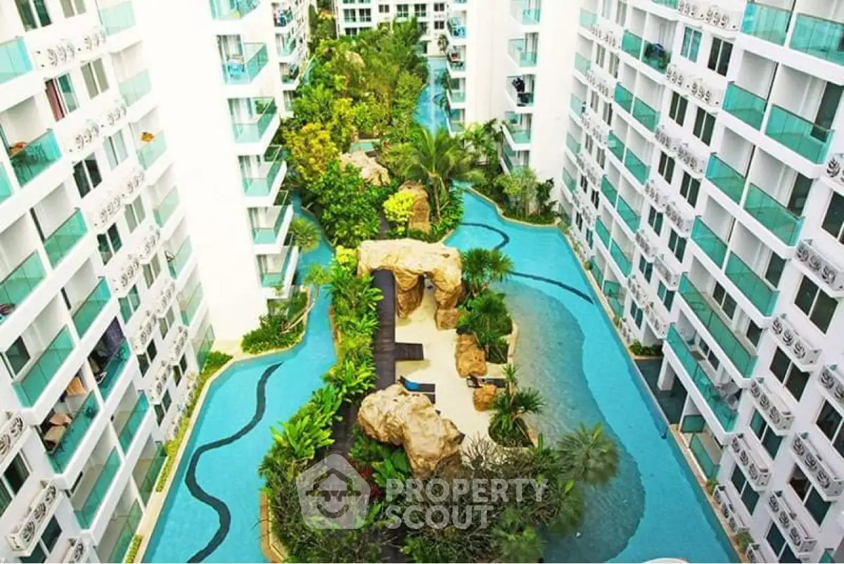 Luxurious condominium with stunning pool and lush greenery in a modern complex.