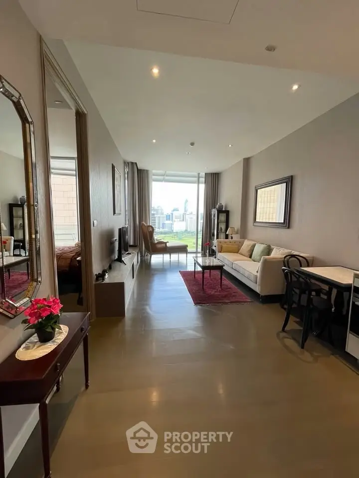 Spacious modern living room with city view, elegant decor, and natural light.