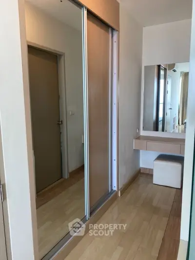 Modern bedroom with sliding closet doors and vanity area