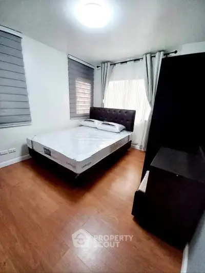 Cozy bedroom with modern decor and natural light, featuring a comfortable bed and stylish window treatments.