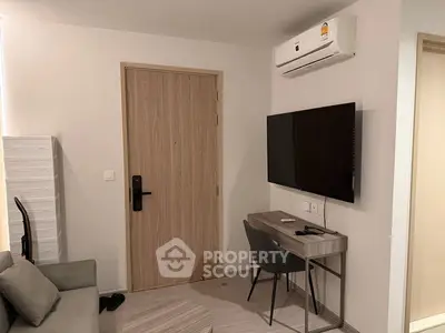 Modern apartment interior with sleek furniture and wall-mounted TV