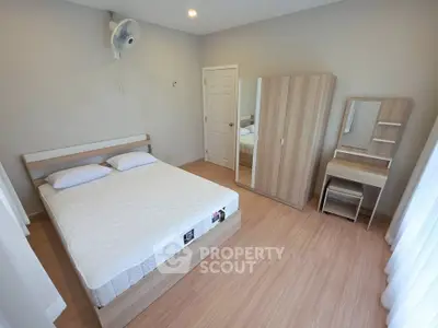 Spacious bedroom with modern wooden furniture and natural light