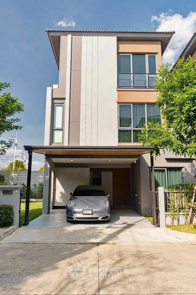 Modern three-story townhouse with sleek design and carport, perfect for urban living.