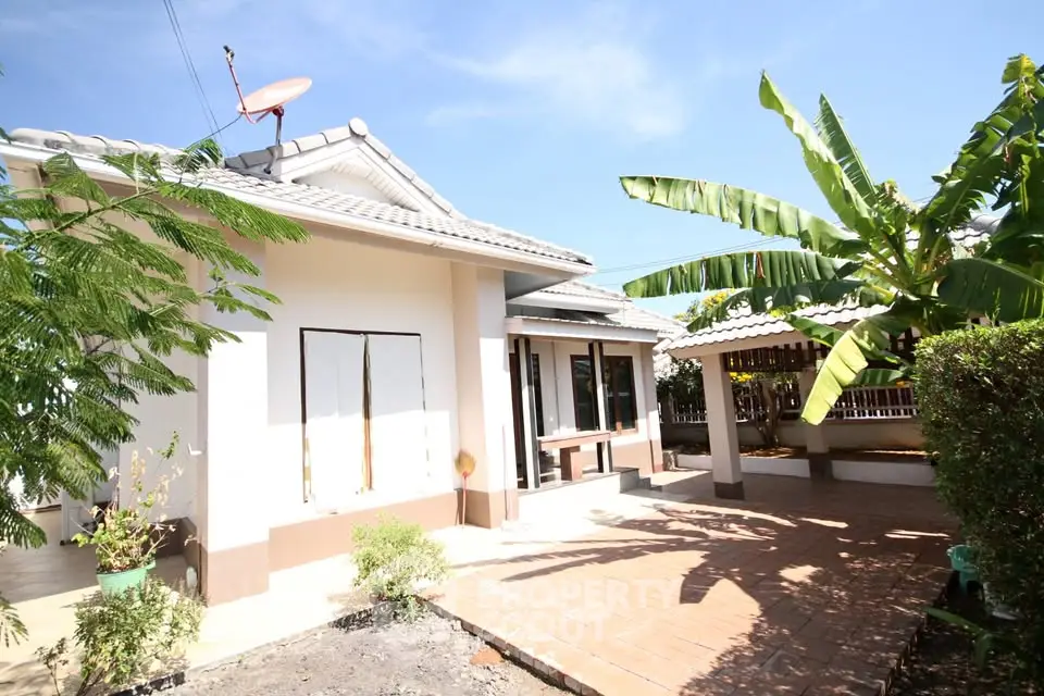Charming single-story home with lush garden and spacious patio area.
