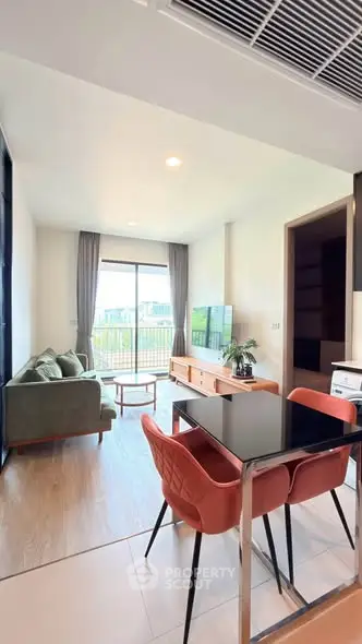 Modern living room with stylish furniture and large window offering a great view