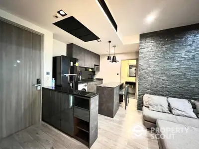 Modern kitchen with sleek design, open layout, and stylish stone accent wall.