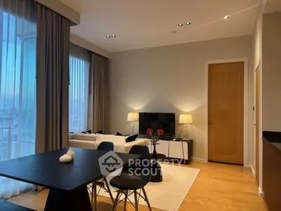 Modern living room with elegant decor and city view, featuring stylish furniture and ambient lighting.