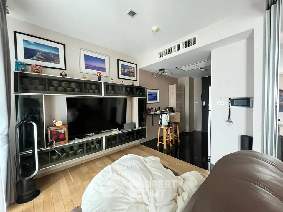 Modern living room with sleek entertainment center and open kitchen layout