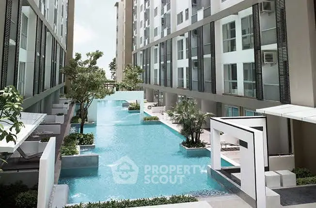 Luxurious modern apartment complex with stunning pool and lush greenery.