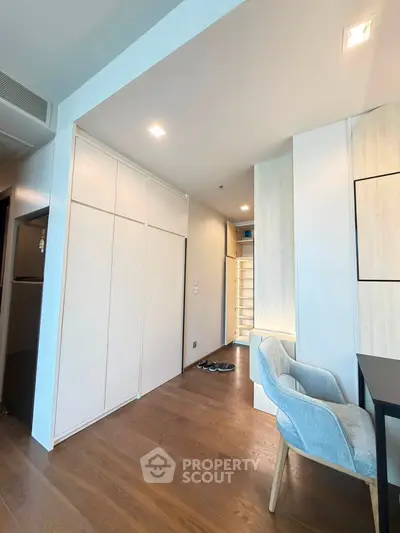 Modern apartment interior with sleek wooden flooring and stylish furniture, showcasing a cozy and inviting living space.