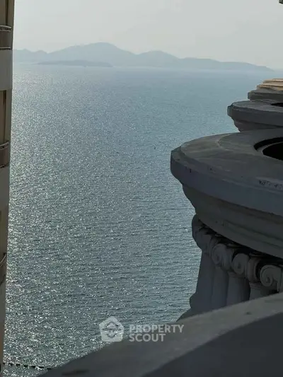Stunning ocean view from a high-rise balcony with classical architectural details.