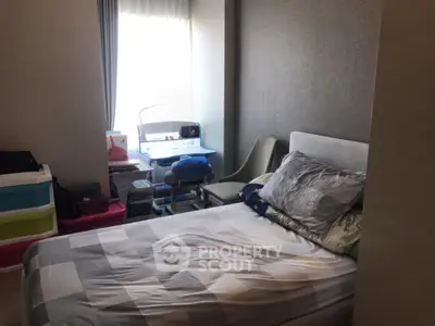 Cozy bedroom with natural light and modern decor, perfect for relaxation and productivity.