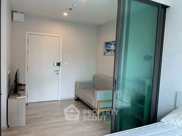 Modern apartment interior with sliding glass door and cozy furnishings