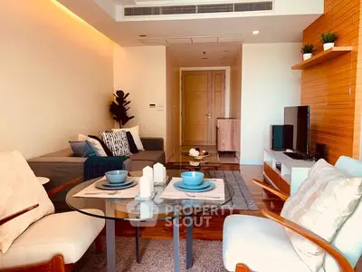 Modern living room with stylish furniture and decor, featuring a cozy seating area and elegant dining setup.