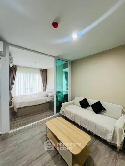 Modern apartment interior with cozy living room and bedroom, featuring stylish decor and natural light.