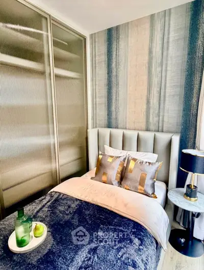 Stylish bedroom with modern decor and cozy bedding in a contemporary apartment.