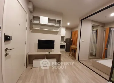 Modern living room with TV, open layout, and wooden flooring