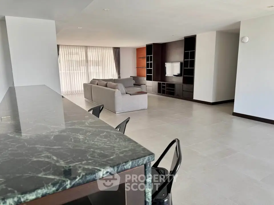 Spacious modern living room with elegant marble countertop and cozy seating area.