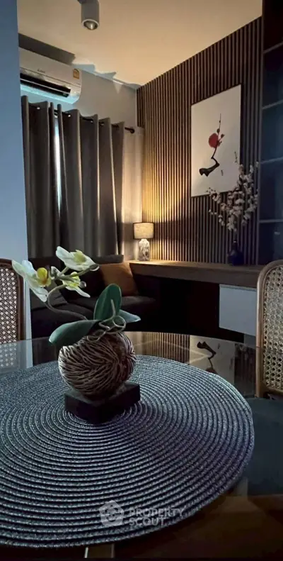 Stylish living room with modern decor and ambient lighting, featuring a cozy seating area and elegant wall art.