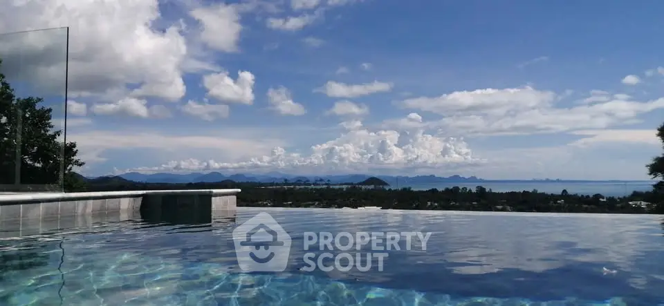 Stunning infinity pool with breathtaking panoramic view of mountains and sky.