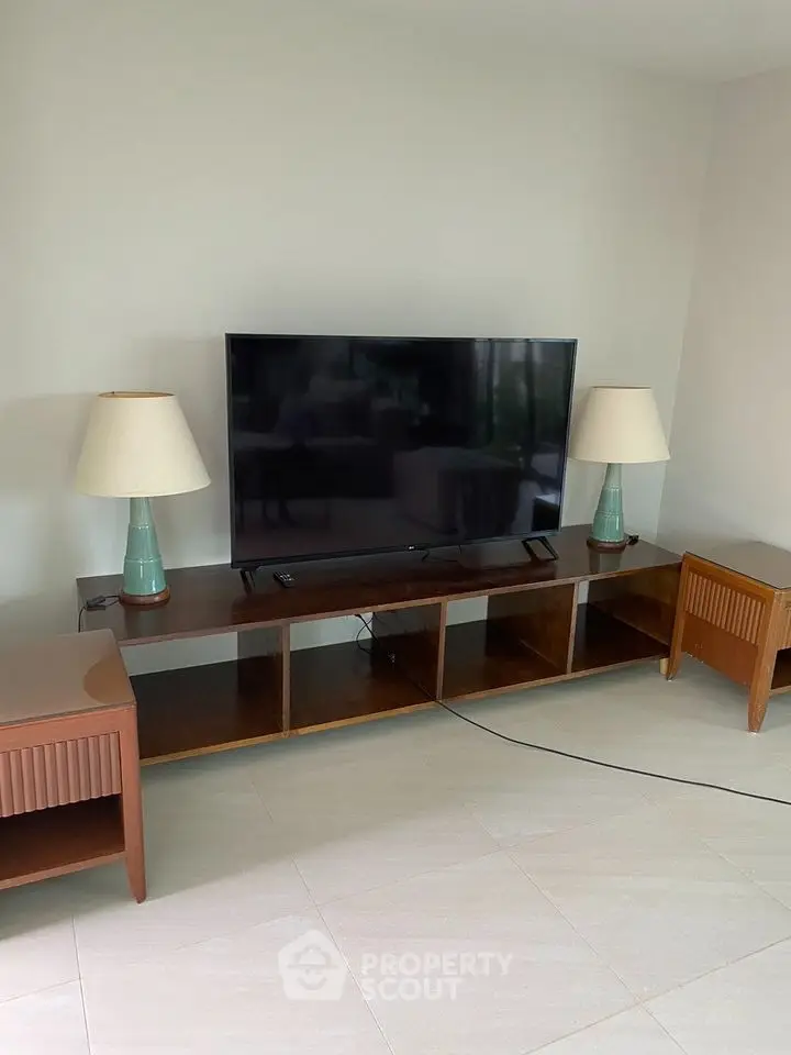 Modern living room with sleek TV setup and stylish wooden furniture