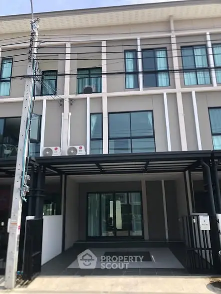 Modern townhouse exterior with sleek design and large windows, perfect for urban living.