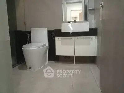 Modern bathroom with sleek fixtures and contemporary design.