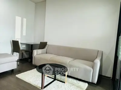 Modern living room with sleek sofa and glass coffee table on plush rug