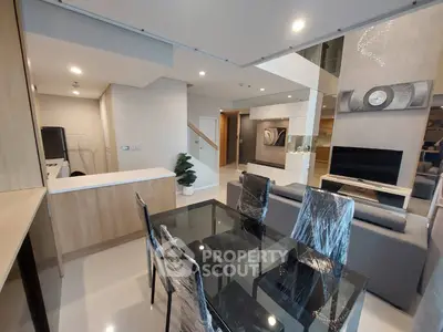 Modern open-plan living room with stylish dining area and contemporary decor