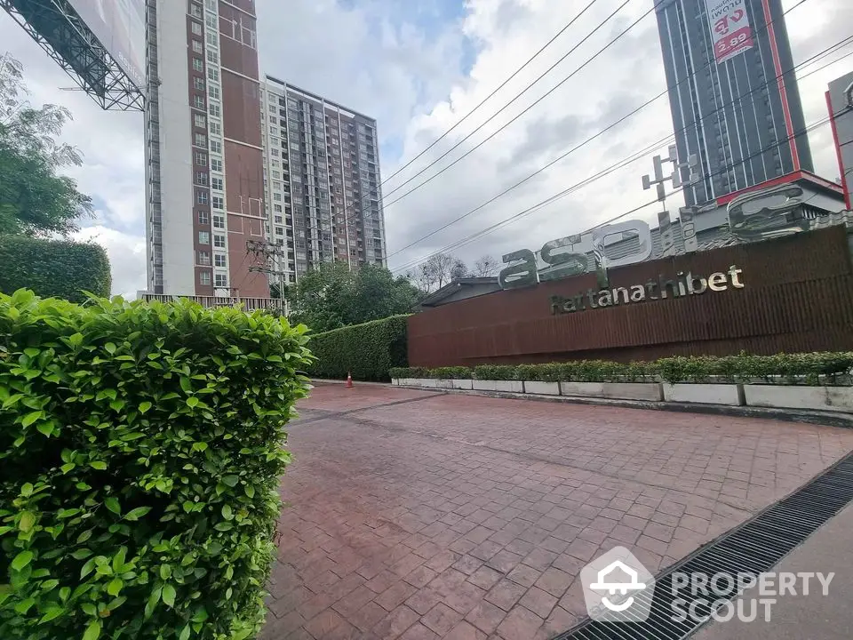 Modern condominium exterior with lush greenery and spacious entrance