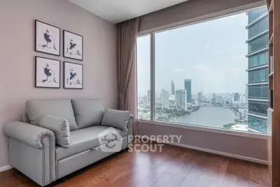 Stylish living room with stunning city and river view, featuring elegant decor and comfortable seating.