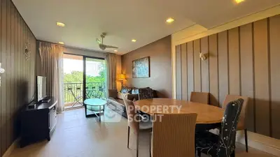 Spacious living room with elegant decor and balcony view, perfect for relaxation and entertaining.