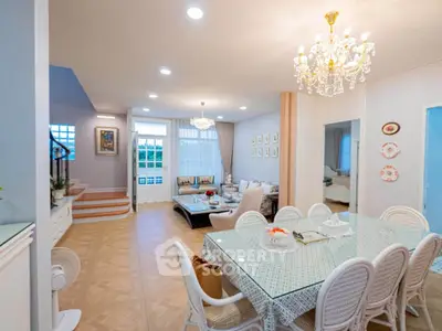 Elegant living and dining area with chandelier and stylish decor